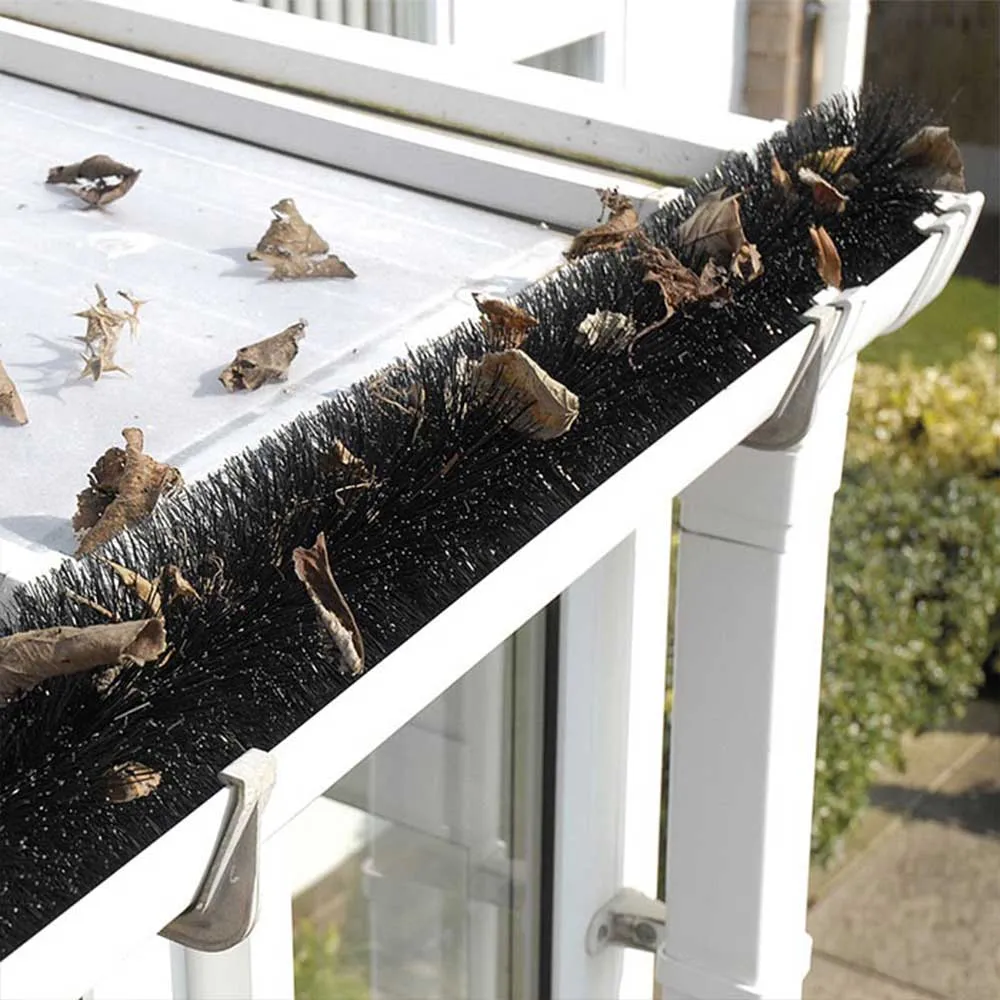 Gutter brush with leaves sitting ontop